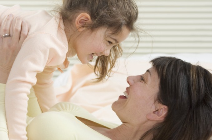 Mother and Daughter Playing on Bed